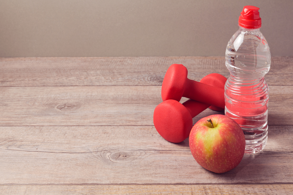 Healthy lifestyle concept with bottle of water and apple